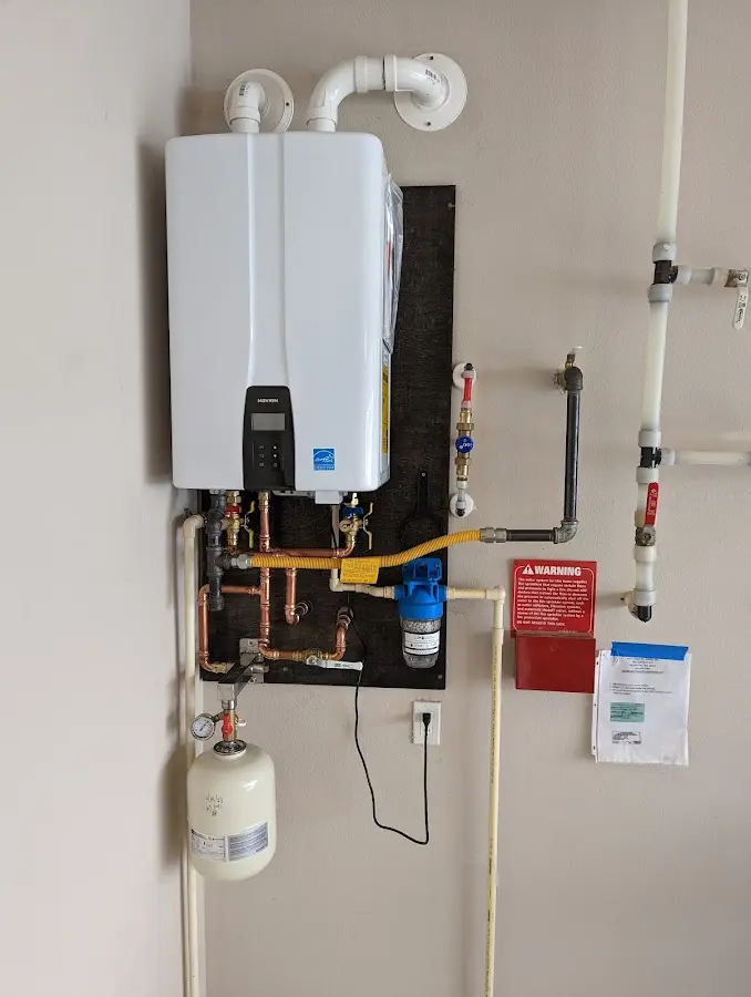 Professional plumber installing copper piping in a Polk home